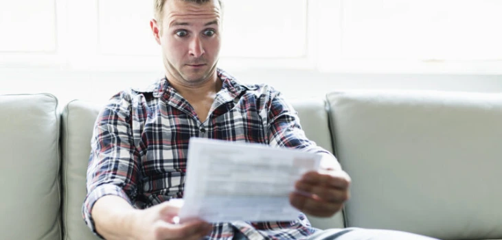 Chiller Portable AC surprised guy reads envelope with high air conditioner electric bills