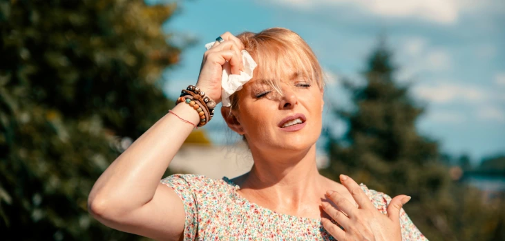 Chiller Portable AC lady sweating in heatwave holding a tissue