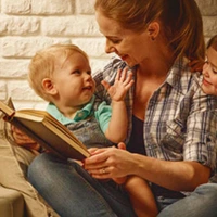 lady reading stories to baby while enjoying Chiller Portable AC